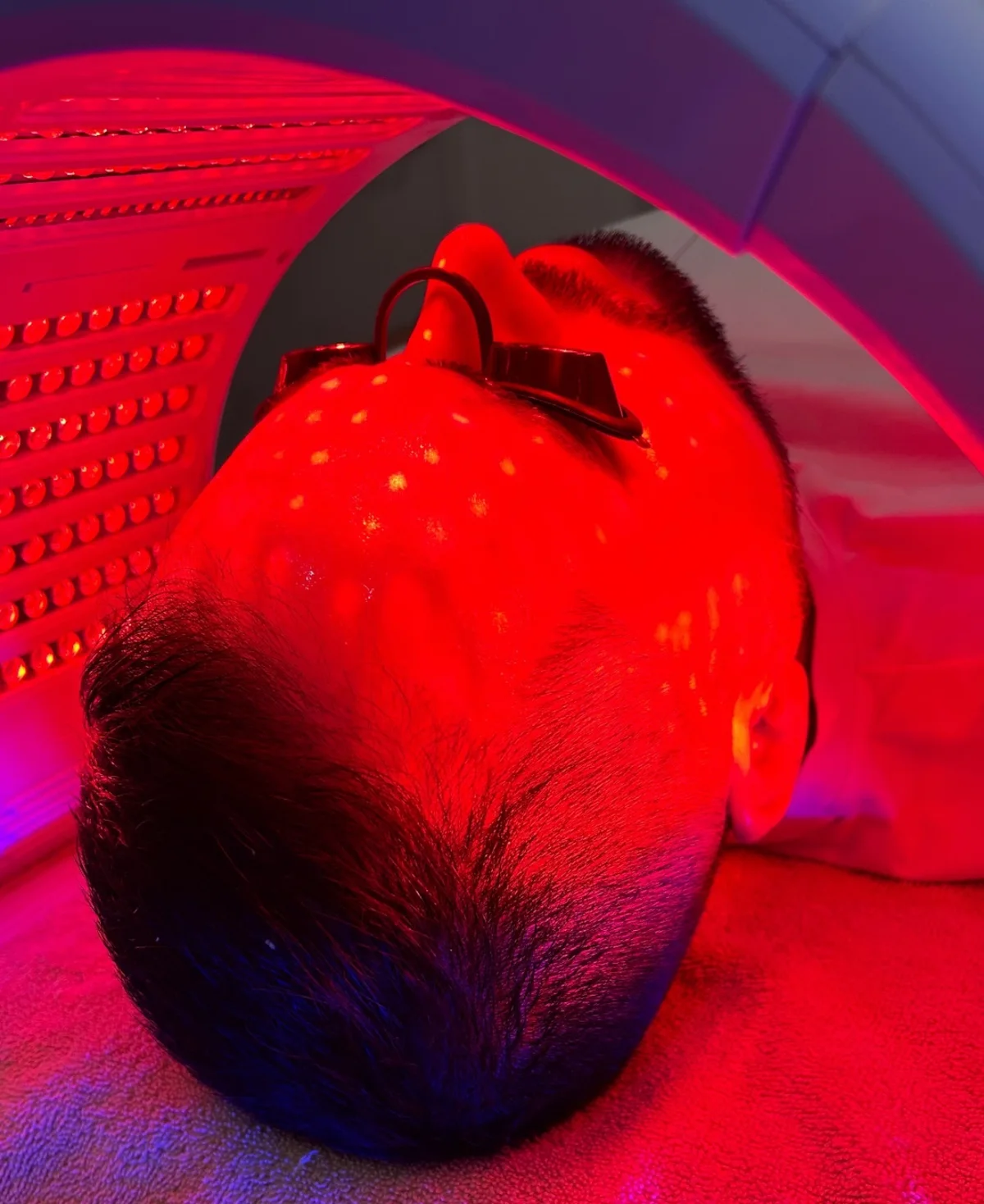 A man receiving Hydrafacial with LED red light therapy at NECTAR body•face•skin in DeWitt MI